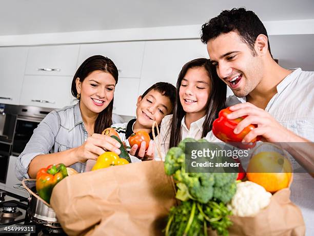 happy family cooking - latin american and hispanic shopping bags stock pictures, royalty-free photos & images