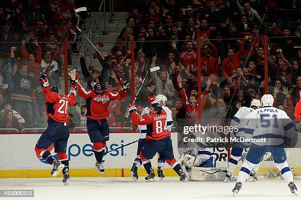 The Washington Capitals celebrate after Alex Ovechkin after scored a goal in the third period during an NHL game against the Tampa Bay Lightning at...