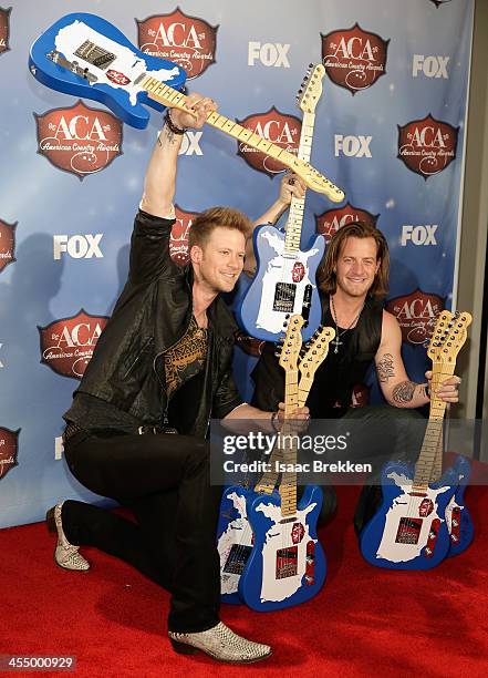 Recording artists Tyler Hubbard and Brian Kelley of Florida Georgia Line pose with the awards for Artist of the Year: New Artist, Single of the Year,...