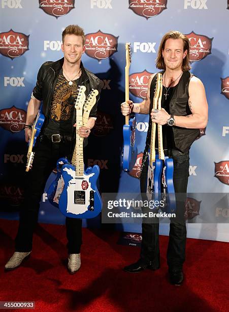 Recording artists Tyler Hubbard and Brian Kelley of Florida Georgia Line pose with the awards for Artist of the Year: New Artist, Single of the Year,...