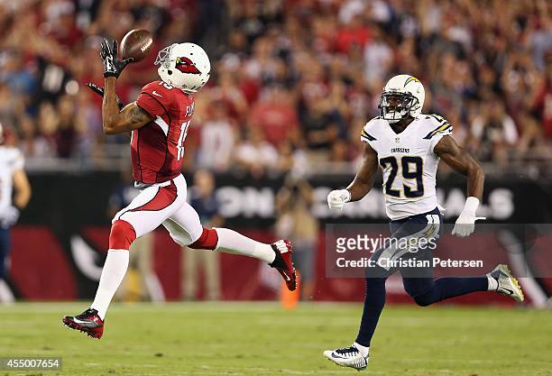Wide receiver Michael Floyd of the Arizona Cardinals makes a 63 yard reception past cornerback Shareece Wright of the San Diego Chargers in the first...