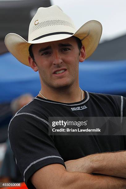 Austin Dillon, driver of the American Ethanol Chevrolet, stands in the garage area during the NASCAR Camping World Truck Series inaugural CarCash...