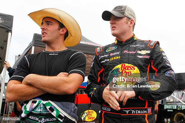 Austin Dillon, driver of the American Ethanol Chevrolet, and Ty Dillon, driver of the Bass Pro Shop/Tracker Boats Chevrolet, stand in the garage area...