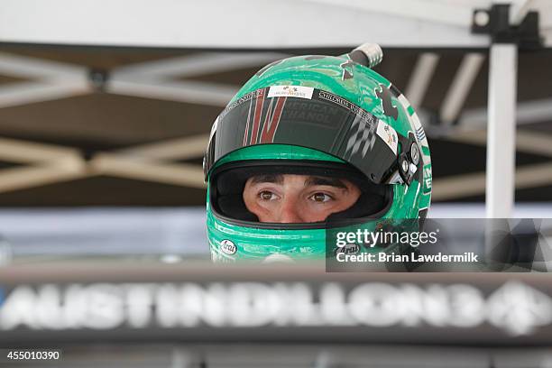 Austin Dillon, driver of the American Ethanol Chevrolet, stands in the garage area during the NASCAR Camping World Truck Series inaugural CarCash...