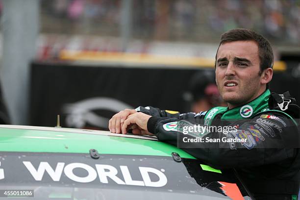 Austin Dillon, driver of the American Ethanol Chevrolet, stands in the garage area during the NASCAR Camping World Truck Series inaugural CarCash...