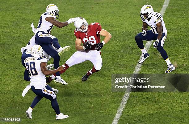 Tight end John Carlson of the Arizona Cardinals makes a 29 yard reception in the first quarter against the San Diego Chargers defense during the NFL...