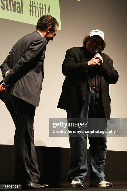 Moderator Thom Powers and Director / Executive Producer Michael Moore speak during the 25th Anniversary screening of "Roger & Me" during the 2014...