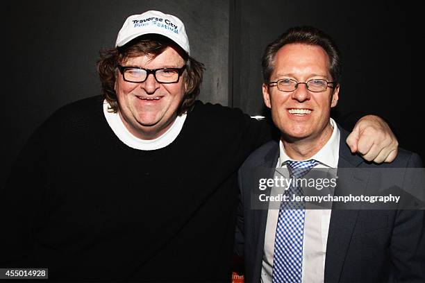 Director / Executive Producer Michael Moore and moderator Thom Powers pose for a portrait during the 25th Anniversary screening of "Roger & Me"...