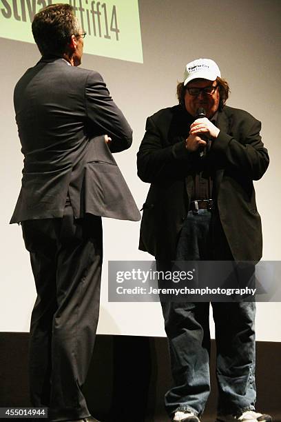 Moderator Thom Powers and Director / Executive Producer Michael Moore speak during the 25th Anniversary screening of "Roger & Me" during the 2014...