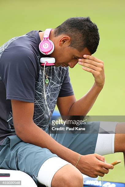 Nick Kyrgios checks his phone during the Davis Cup practice session ahead of the weekend's World Group Qualifier tie between Australia and Uzbekistan...