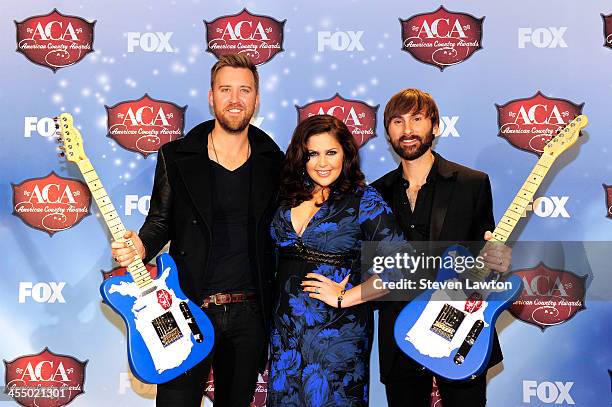 Musicians Charles Kelly, Hillary Scott and Dave Haywood of Lady Antebellum pose in th press room during the American Country Awards 2013 at the...