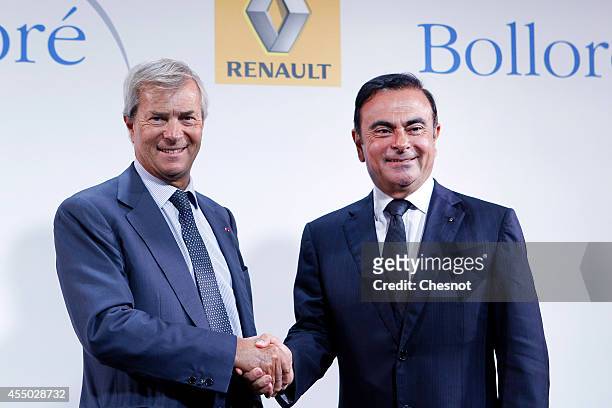 The CEO of French carmaker Renault, Carlos Ghosn , shakes hands with French industrial group Bollore's head Vincent Bollore at the end of a press...