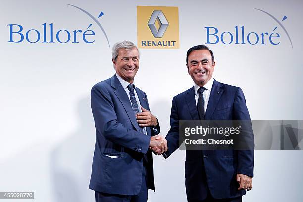 The CEO of French carmaker Renault, Carlos Ghosn , shakes hands with French industrial group Bollore's head Vincent Bollore at the end of a press...