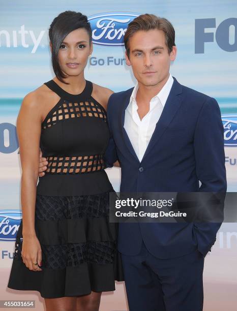 Actors Jessica Lucas and Kevin Zegers arrive at the 2014 FOX Fall Eco-Casino Party at The Bungalow on September 8, 2014 in Santa Monica, California.