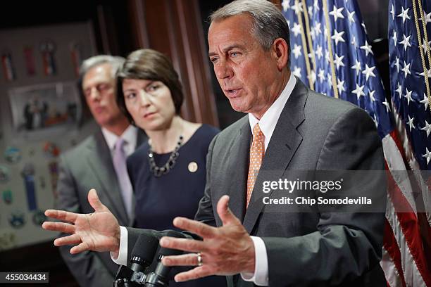 Speaker of the House John Boehner takes reporters' questions after a closed-door conference meeting with Majority Leader Kevin McCarthy and Rep....