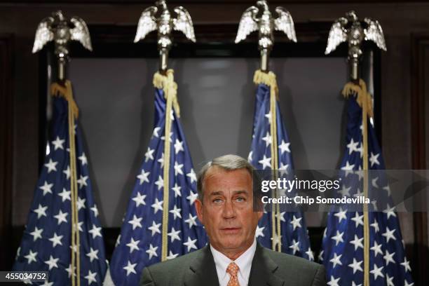 Speaker of the House John Boehner takes reporters' questions following a closed-door conference meeting at the Republican National Committee...