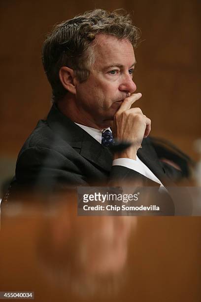 Sen. Rand Paul listen to witnesses talk about military equipment given to local law enforcement departments by the federal government during a Senate...