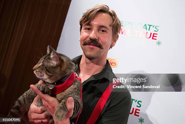 Oskar the Blind Cat and Mick Szydlowski attend the Internet Cat Super Group Holiday Unveiling event at Capitol Records Tower on December 10, 2013 in...