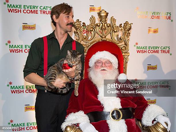 Mick Szydlowski, Oskar the Blind Cat and Santa Claus attend the Internet Cat Super Group Holiday Unveiling event at Capitol Records Tower on December...