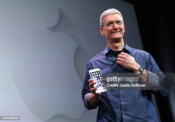 Apple CEO Tim Cook shows off the new iPhone 6 and the Apple Watch during an Apple special event at the Flint Center for the Performing Arts on...