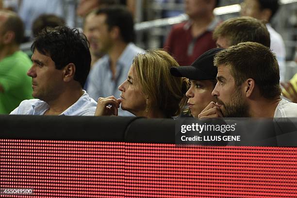 Barcelona's defender Gerard Pique and his wife Colombian singer Shakira attend the 2014 FIBA World basketball championships quarter-final match...