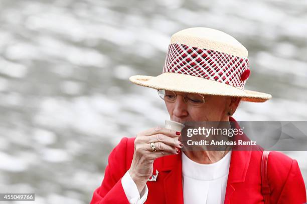 Queen Margrethe II of Denmark has a shot upon her arrival to board the remake of a Viking ship on September 9, 2014 in Berlin, Germany. Queen...