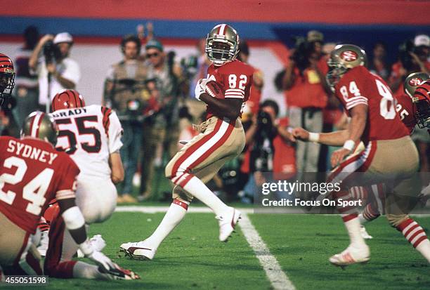 John Taylor of the San Francisco 49ers runs with the ball against the Cincinnati Bengals during Super Bowl XXIII on January 22, 1989 at Joe Robbie...