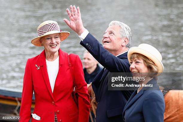 Queen Margrethe II of Denmark , German President Joachim Gauck and German First Lady Daniela Schadt wave to onlookers upon their arrival to board the...