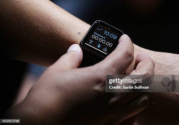 An attendee inspects the new Apple Watch during an Apple special event at the Flint Center for the Performing Arts on September 9, 2014 in Cupertino,...
