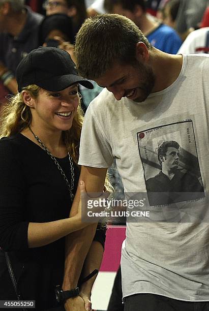 Barcelona's defender Gerard Pique and his wife Colombian singer Shakira attend the 2014 FIBA World basketball championships quarter-final match...