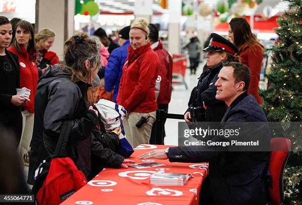 Professional hockey player Dion Phaneuf signs autographs during an in-store Holiday appearance at Target at Shoppers World Danforth on December 10,...