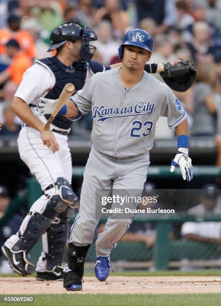 Norichika Aoki of the Kansas City Royals tosses down his bat as he heads for first base on a walk as catcher Alex Avila of the Detroit Tigers directs...