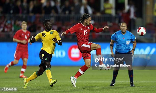 Issey Nakajimi-Farran of Canada battles for the ball with Simon Dawkins of Jamaica during the International Friendly match between Canada and Jamaica...