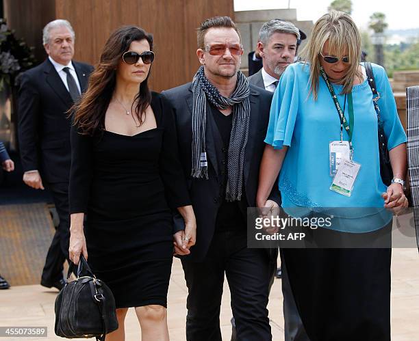 Bono and his wife, Alison Hewson and Nelson Mandela's former assistant, Zelda le Grange leave after seeing the coffin of former South African...