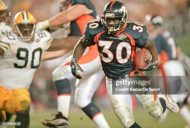 Terrell Davis of the Denver Broncos carries the ball against the Green Bay Packers during Super Bowl XXXII on January 25, 1998 at Qualcomm Stadium in...