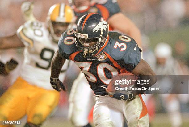 Terrell Davis of the Denver Broncos carries the ball against the Green Bay Packers during Super Bowl XXXII on January 25, 1998 at Qualcomm Stadium in...