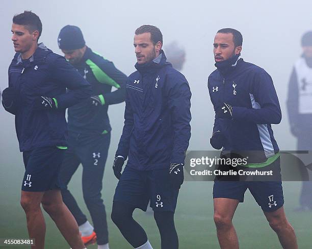 Erik Lamela, Roberto Soldado and Andros Townsend take part in the warm up during Tottenham Hotspur training session ahead of their UEFA Europa League...