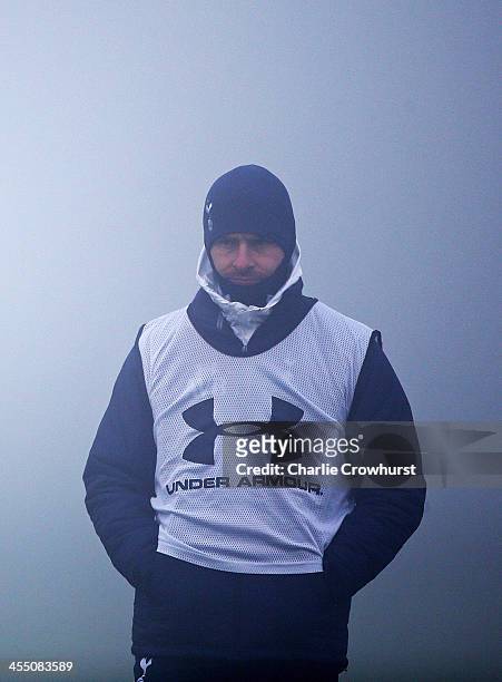 Manager Andre Villas-Boas keeps an eye on the session in the fog during Tottenham Hotspur training session ahead of their UEFA Europa League group...