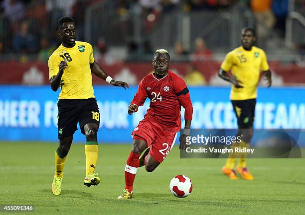 Randy Edwini-Bonsu of Canada gets past Simon Dawkins of Jamaica during the International Friendly match between Canada and Jamaica at BMO Field on...