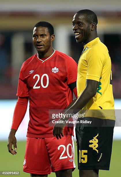 Patrice Bernier of Canada laughs with Je-Vaughn Watson of Jamaica during the International Friendly match between Canada and Jamaica at BMO Field on...