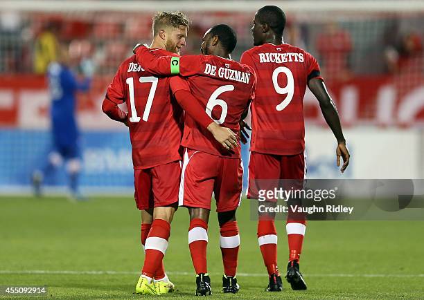 Captain Julian De Guzman of Canada congratulates goalscorer Marcel De Jong during the International Friendly match between Canada and Jamaica at BMO...