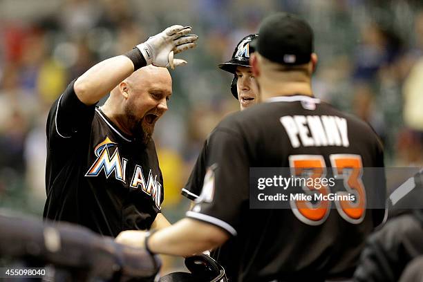 Casey McGehee of the Miami Marlins celebrates after hitting a two-run homer in the top of the ninth inning against the Milwaukee Brewers at Miller...