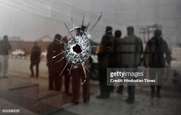 Bullet pierces through the window glass at the site of shootout at Nowgam bypass on December 11, 2013 on the outskirts of Srinagar, India. One CRPF...