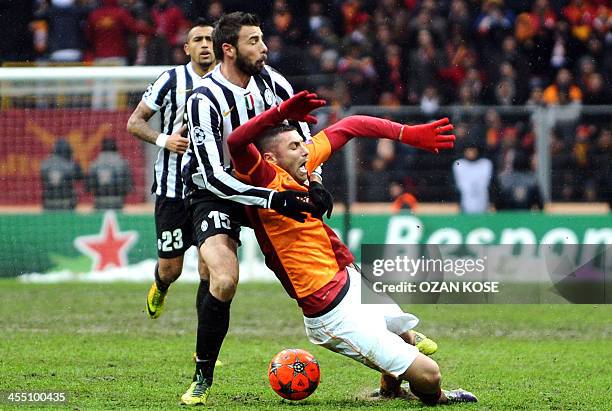 Galatasaray's Burak Yilmaz is fouled by Juventus' Andrea Barzagli during the UEFA Champions League group B football match between Galatasaray and...