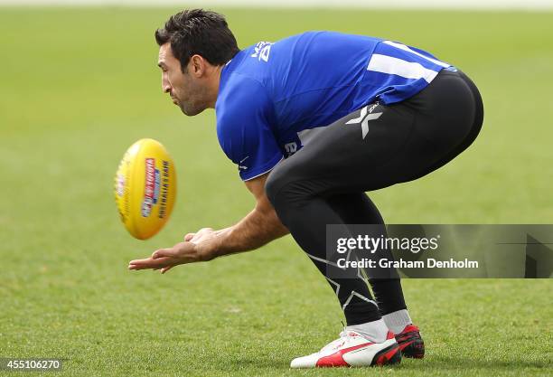 Michael Firrito of the Kangaroos marks during a North Melbourne Kangaroos AFL training session at Arden Street Ground on September 10, 2014 in...