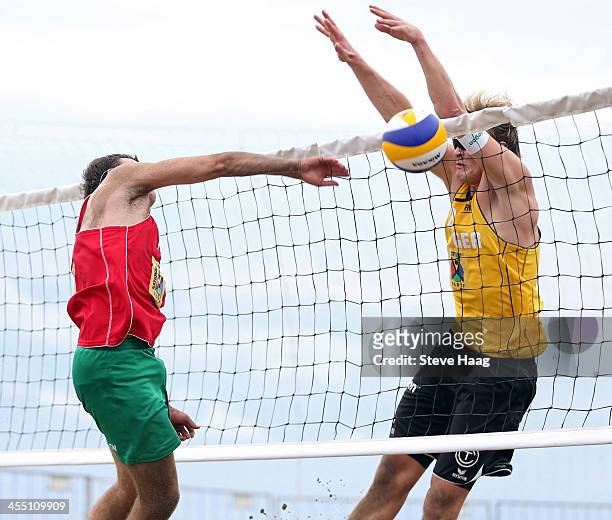 Ostap Firsov of Russia has his hammper blocked by Philipp Arne Bergmann of GER during the FIVB Durban Open at New Beach on December 11, 2013 in...