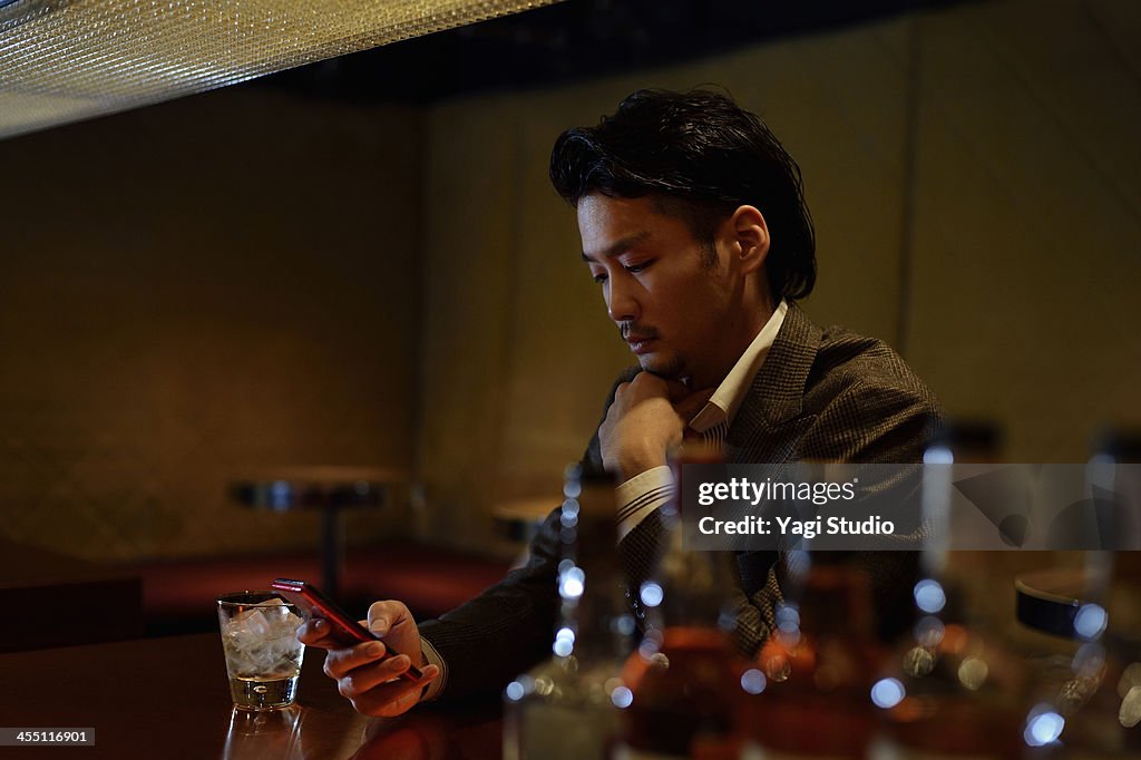 Man using smart phone in the bar