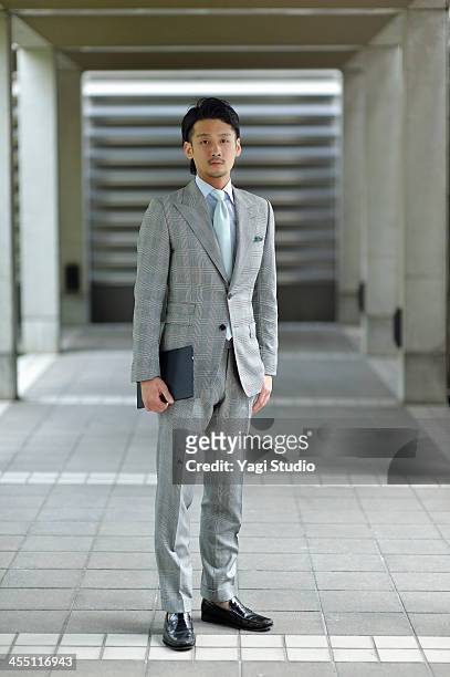 businessman standing with digital tablet - grey suit foto e immagini stock