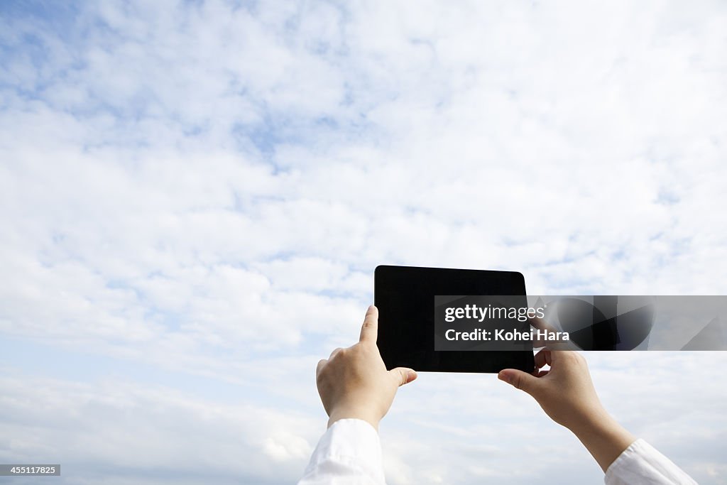 A woman using a digital tablet