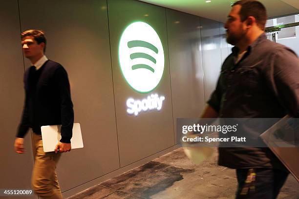 Spotify employees walk out of a news conference where Spotify CEO Daniel Ek announced that the online streaming music service will expand to 20 new...